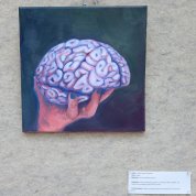 Artwork featuring a hand holding a brain