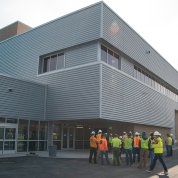 A large building, with many people gathered in front
