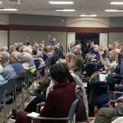 Some audience members raise hands