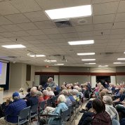 Lorsch and Kauffman stand in a crowded auditorium