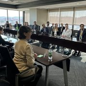 Bertagnolli sits at u-shaped conference table with scientists, UAB leaders.