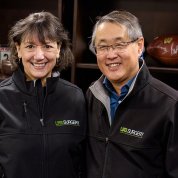 Bertagnolli and Chen pose together, smiling in front of book shelf