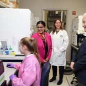 Members from the Japanese delegation stand in a lab