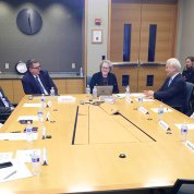 Doctors sit around a conference table