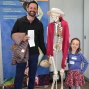 Dad and daughter smiling with full skeleton