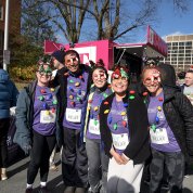 A group photo featuring runners who are wearing a Christmas light necklace