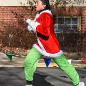 A runner wearing Grinch-colored sweatpants