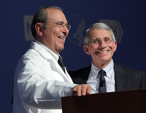 Gallin and Fauci smiling at the podium.