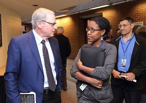 Wachter chats with lecture attendee                                                                 