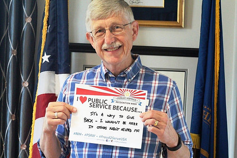 Dr. Collins holds sign supporting PSRW.