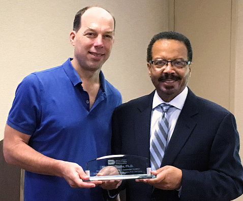 Dr. Quake with Dr. Pettigrew, holding award
