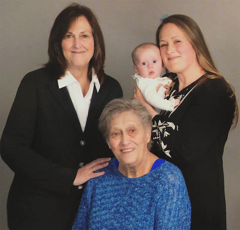 Family photo of Nelson with her mom, daughter and baby granddaughter