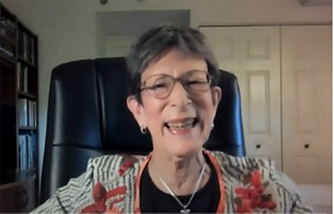 Screenshot of Greenberg, smiling in her home office