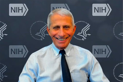 A smiling Fauci on Zoom in front of NIH/HHS backdrop