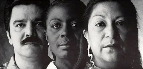Black and white photo from poster of a Latino man with African American and Native American women