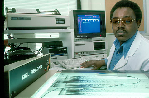 Coleman seated, with scans and computer screen in front of him