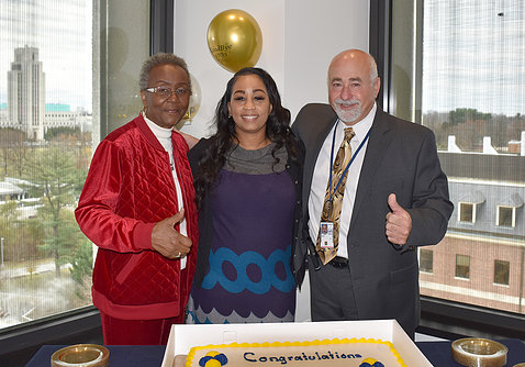 McMullen, Brown and Salah smile behind congratulatory cake