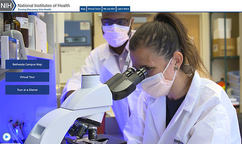 Screenshot of homepage shows a female scientist looking into a microscope with a colleague looking on, with Campus Map, Virtual Tour and Tour at a Glance buttons and several top navigation tabs as well