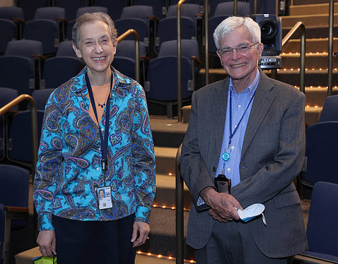 Schor and Gottesman stand together smiling in the amphitheater.