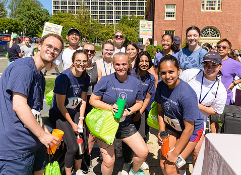 A team poses together with other NIH'ers gathered behind, before the Relay.