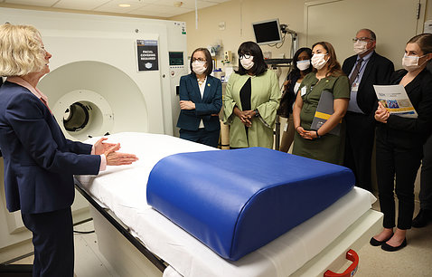 Volkow points hands at MRI scanner as members of Congress and Dr. Tabak watch and listen