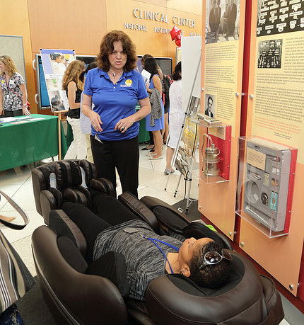 Attendee reclines in massage chair.