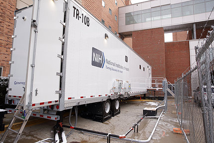 A white trailer featuring the NIH logo and tagline, "Turning Discovery into Health"