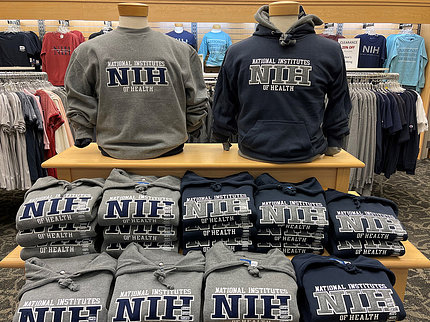 A display in the store featuring crewneck and hooded sweatshirts with NIH's logo. 