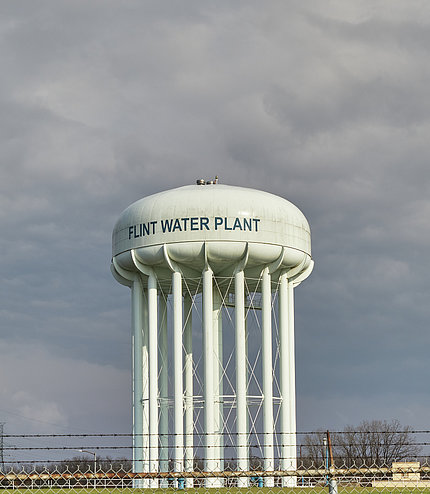 A water tower featuring the words "Flint Water Plant"