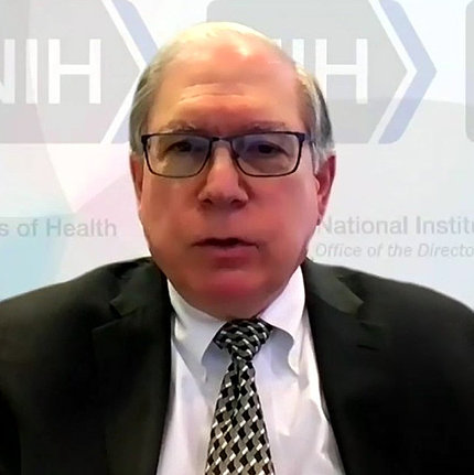 Tabak speaks in front of a NIH Zoom background