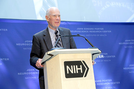 Porter standing at NIH podium