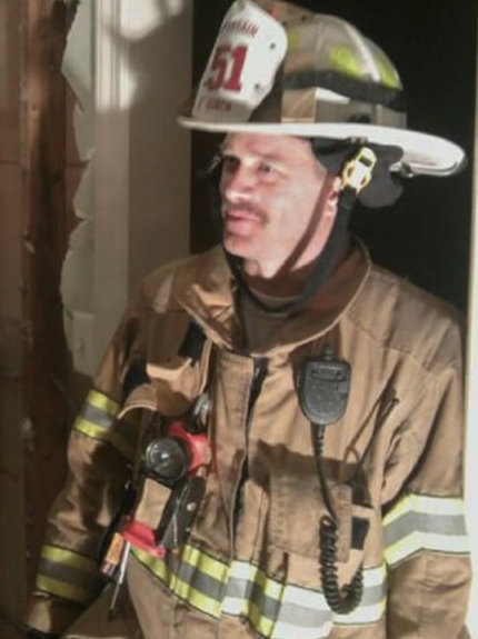 Burch wears fire fighting equipment