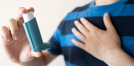 Person holding inhaler