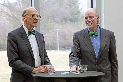 Dr. Roger Glass and Dr. Peter Kilmarx, wearing matching green bow ties.