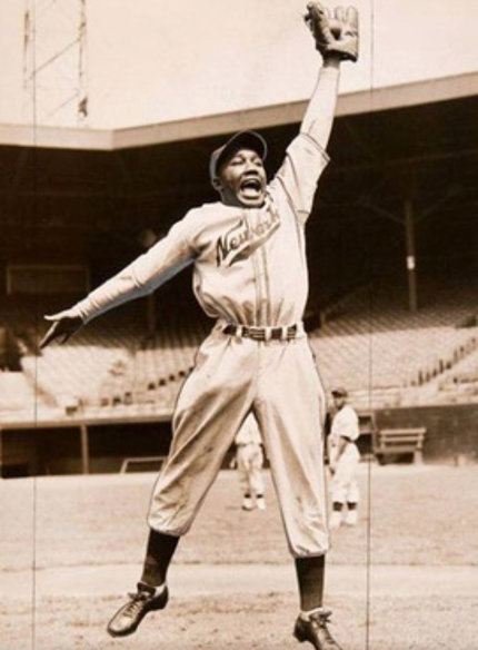 vintage image of Isreal in Newark Eagles jersey leaping to catch a baseball