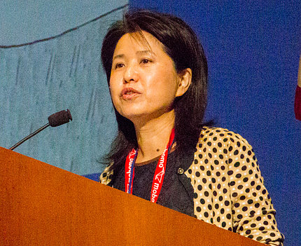 Flora Qian speaks at podium