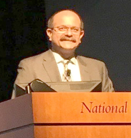 Schiffman at an NIH podium