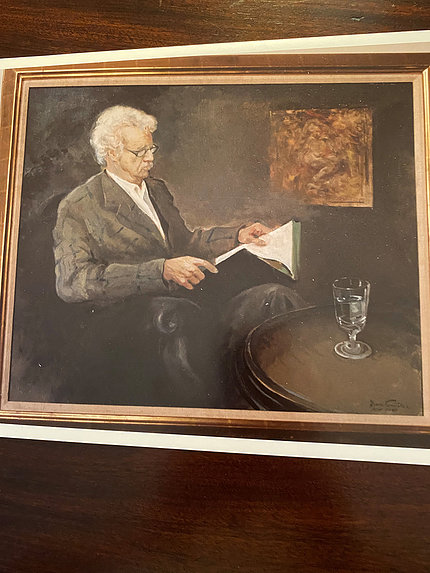 A painting of Wilson reading a book