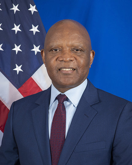 Photo of Nkengasong with an American flag behind him