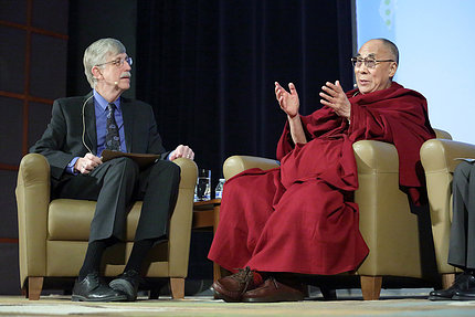 The Dalai Lama and Collins speak to each other on stage