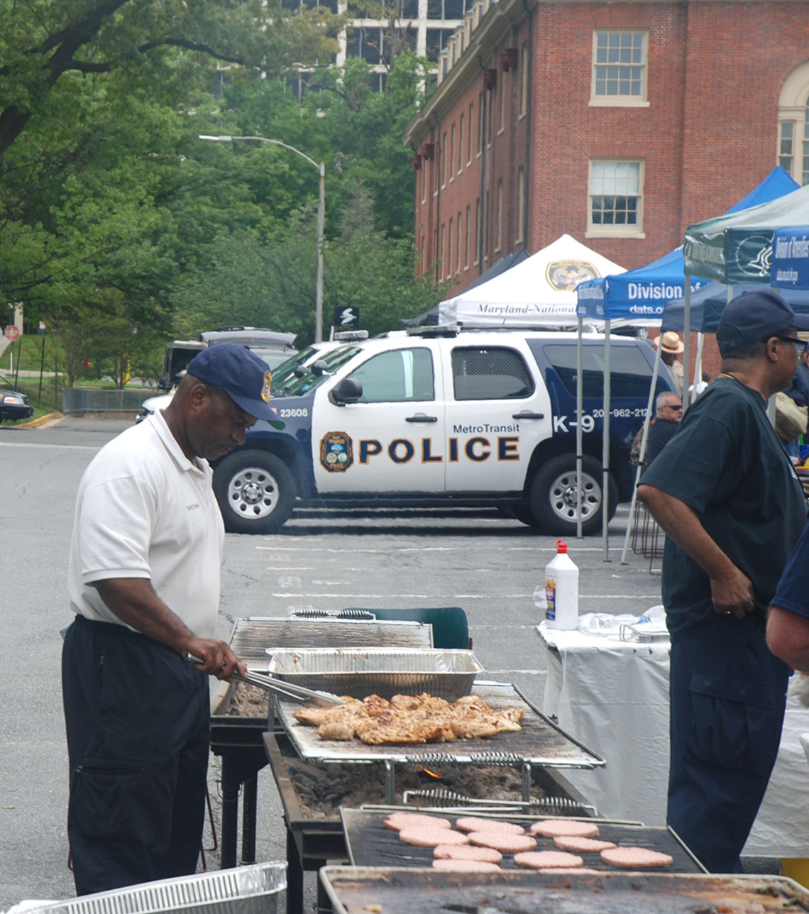 An officer mans the grill.