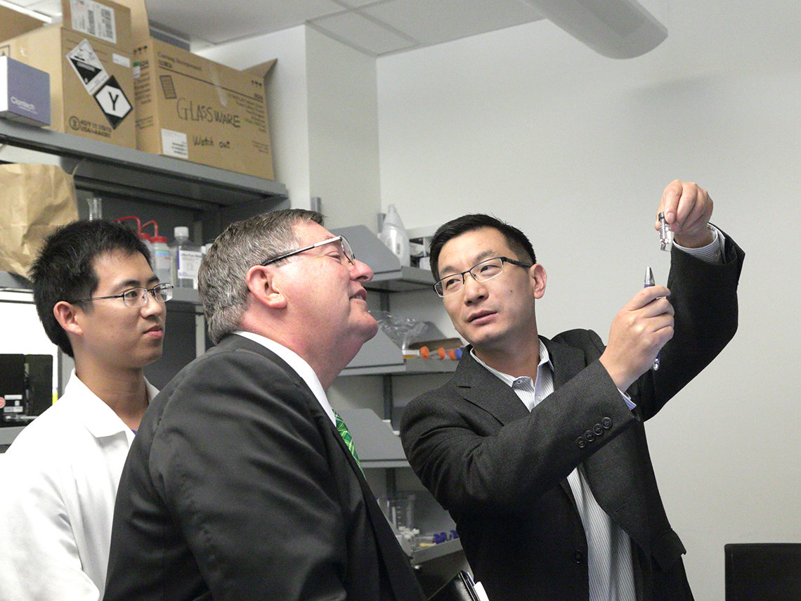  Dr. Chen shows Rep. Burgess an example of the Tyndall effect. 