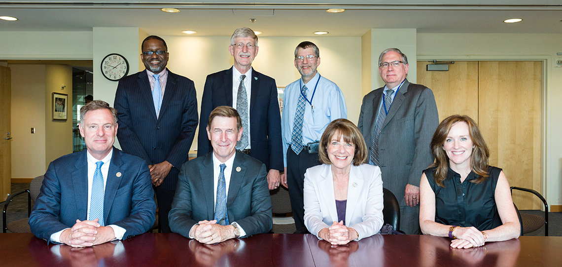 Four Members of Congress who visited NIH pose together with NIH leadership