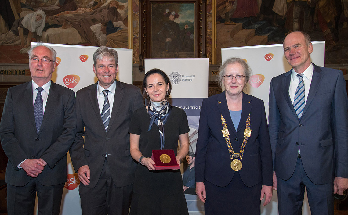 Belkaid proudly displays her Behring Prize medal, at awards ceremony in Germany.