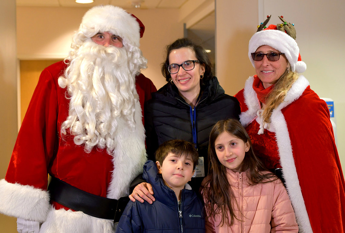 Santa and his wife pose with inn family.