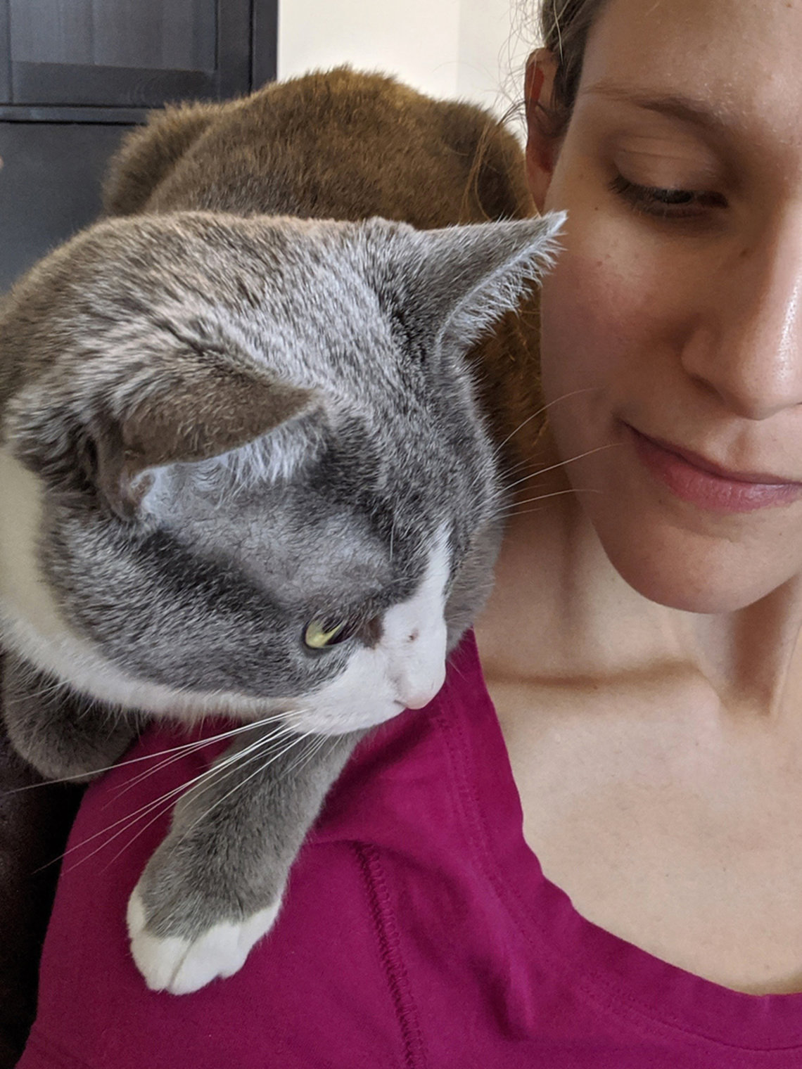 A cat sits on Tempchin's shoulder