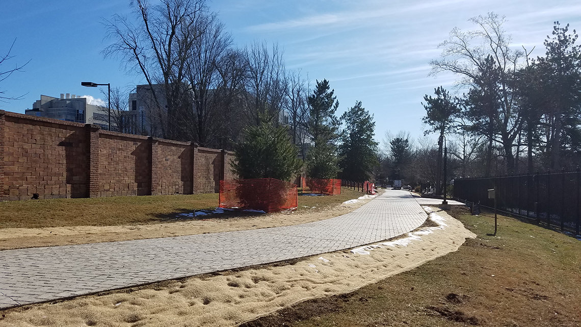 A new winding brick road outside the cloister wall on the NIH campus