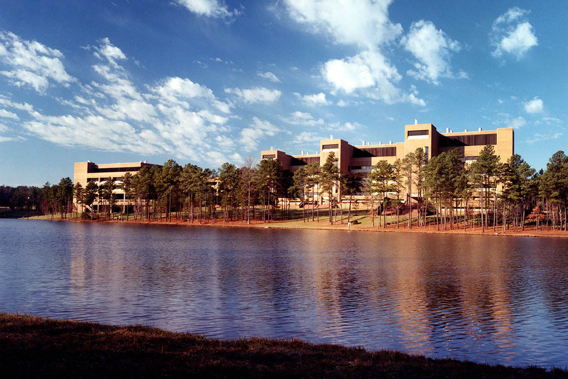 A view from the shore of the lake looking on NIEHS' office buildings