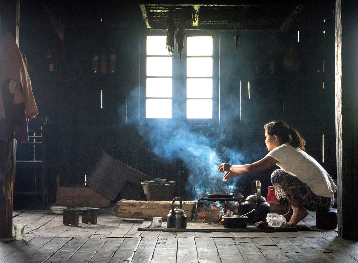 A woman cooks inside her house