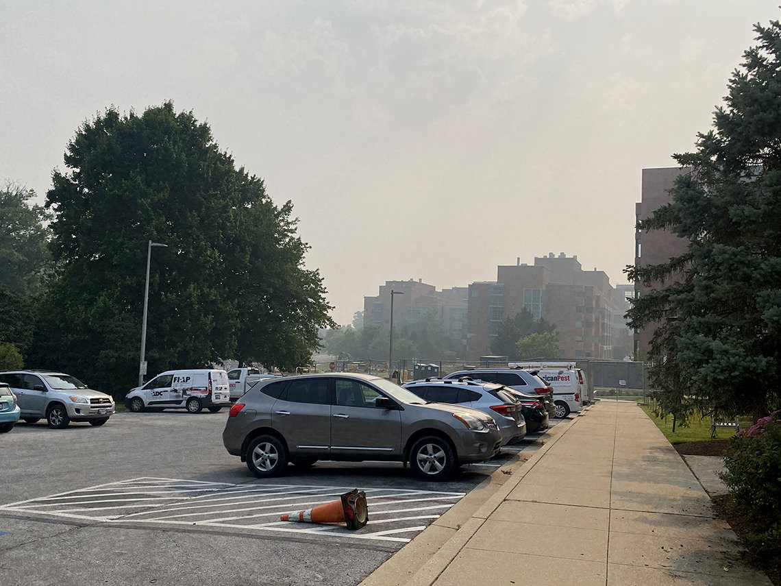 Haze hangs over a parking lot on main campus